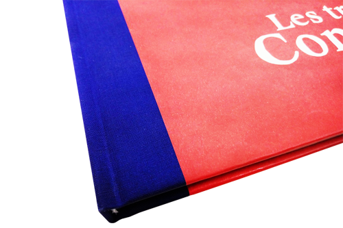 Blauer Stoff und rotes Papier sind eine schöne Kombination von Materialien und Farben für ein gebundenes Buch.